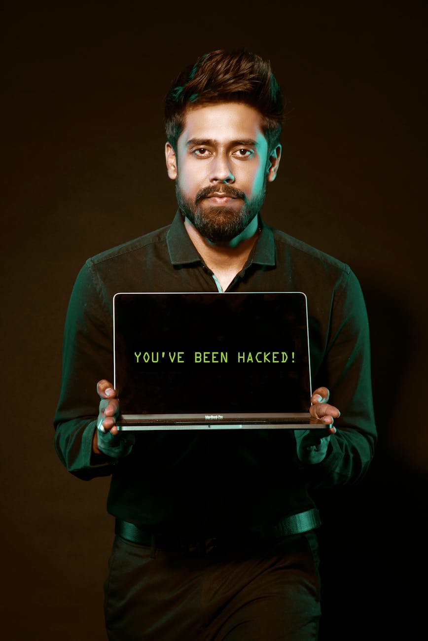 man holding laptop computer with both hands