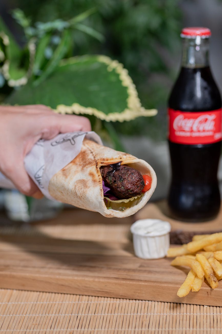 delicious falafel wrap with fries and soda